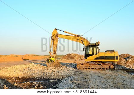 Excavator With Crusher Bucket For Crushing Concrete. Construction Waste Recycling For Construction M