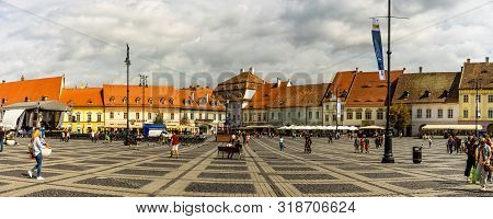 Sibiu, Romania - 2019. Tourist Wondering In The Panoramic The Big Square (piata Mare) Of Sibiu Looki