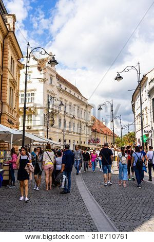 Sibiu, Romania - 2019. People And Tourists Having Lunch And Wandering On The Streets Of Sibiu Old To