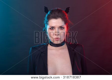 Halloween, Holidays And Carnival Concept - Vamp Woman In Jacket And With Bat Ears In Gothic Style.
