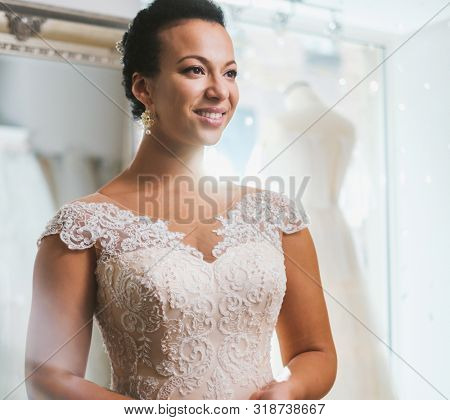 Beautifu bride choosing wedding dress in a wedding salon