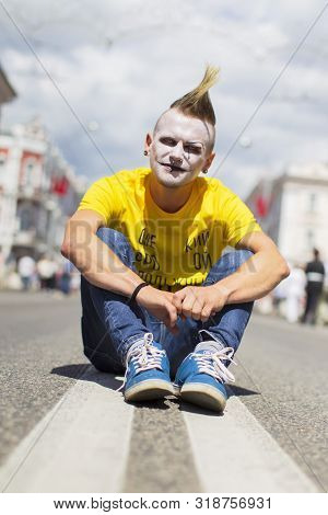 Belarus, The City Of Gimel, July 03, 2019. Youth Festival.the Punk Guy In Bright Clothes Sitting On 