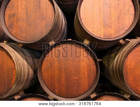 Row Of Wooden Barrels Of Tawny Portwine ( Port Wine ) In Cellar, Porto, Portugal. Vintage Old Style