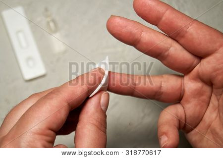 Close Up Of Woman Hands, Cleaning The Finger With An Alcohol Pad For Express Hiv Test