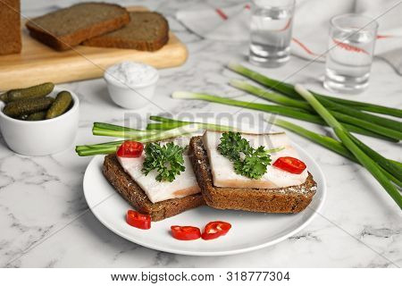 Composition With Plate Of Pork Fatback Sandwiches On Marble Table