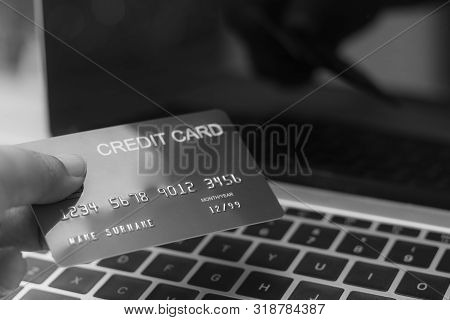 Online Shopping And E-commerce Concept. Using Laptop Keyboard By Hand To Sent The Credit Card Number