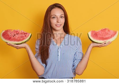 Photo Of Woman Holding Two Pieces Of Watermelon In Hands, Looking Directly At Camera With Charming S