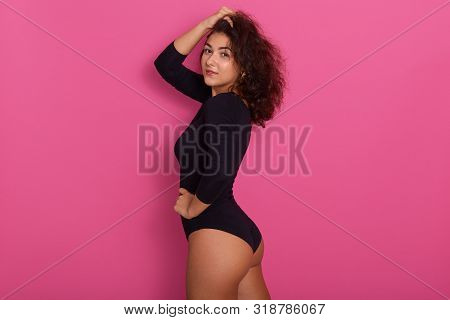 Close Up Portrait Of Beautiful Young And Passionate Woman Wearing Black Kombidress With Long Sleeve,