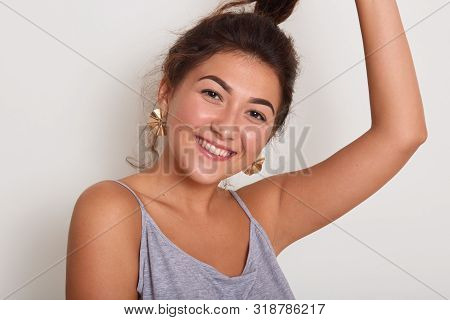 Close Up Portrait Of Cute And Smiling Lady With Dark Wavy Hair, Young Girl With Pony Tail Looking Di