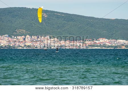 Sunny Beach, Bulgaria July 13, 2019. The Man Practices Hydrofoil Kitesurfing In The Black Sea Off Th