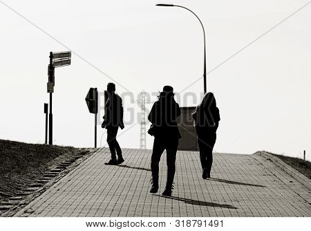 Tourists On The Way To The Trough Bridge In Hohenwarthe Near Magdeburg In The Back Light