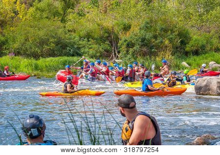 Myhiya, Ukraine - August 17, 2019: Playboating. A Company Of Young Freestyle Kayakers. A Short Break