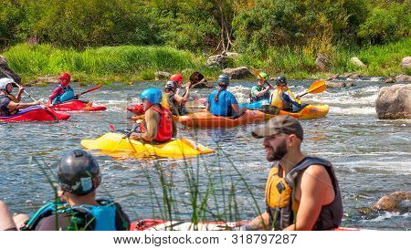 Myhiya, Ukraine - August 17, 2019: Playboating. A Company Of Young Freestyle Kayakers. A Short Break