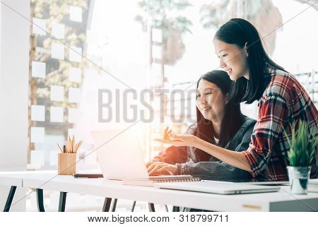 Young Studebt Sitting In Library College Studying And Sharing Knowledge With Laptop Together, Educat