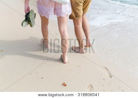 couple wallking on the sandy beach