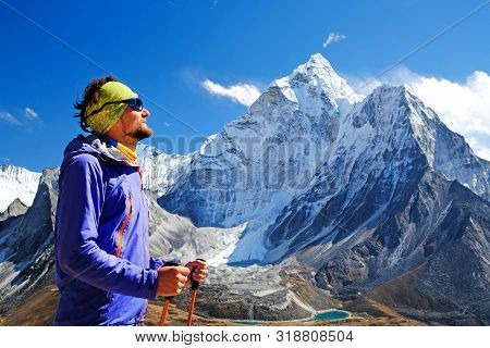 Happy Man Traveler With Backpack Hiking In Himalayas With Ama Dablam Mountain Background. Mountainee