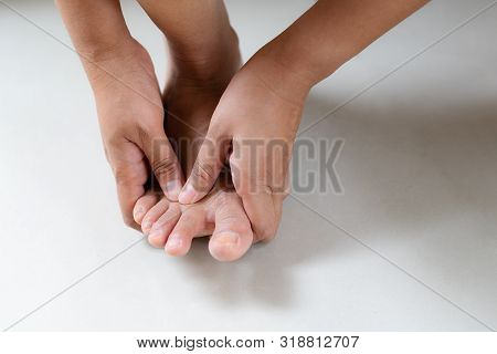 Woman Massaging Her Painful Foot And Finger, Healthcare And Medical Concept