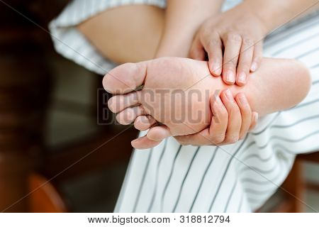 Woman Massaging Her Painful Barefoot, Healthcare And Medical Concept