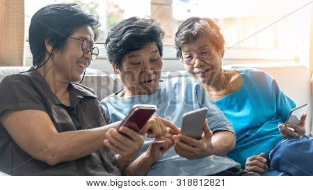 Aging Society Concept With Asian Elderly Senior Adult Women Sisters  Using Mobile Digital Smart Phon
