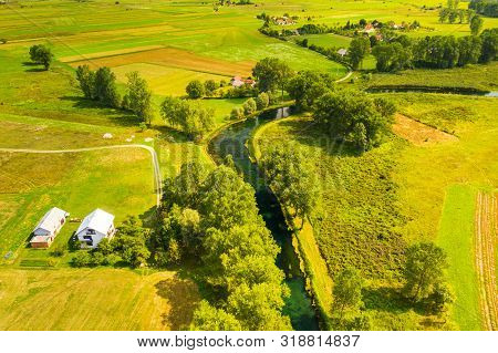 Croatia, Countryside Landscape, Small Village By Gacka River In Region Of Lika, Aerial View