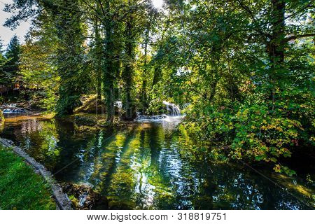 Calm flow of the forest river after a waterfall. Travel to Croatia. The Croatian town of Slunj. Cascade of waterfalls on the Sluncica River. The concept of ecological, active and photo tourism