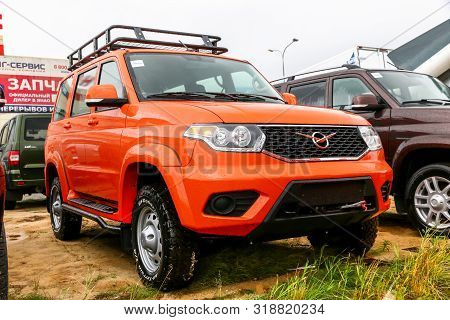Novyy Urengoy, Russia - August 24, 2019: Orange Brand New Offroad Car Uaz 3163 Patriot In The City S