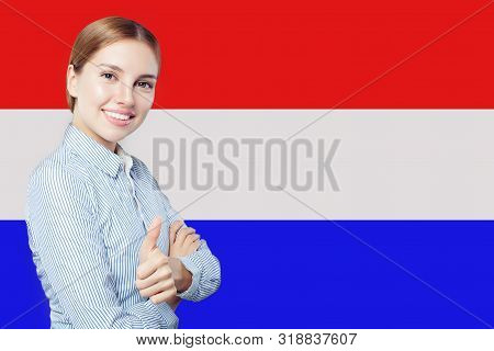 Love Netherlands! Happy Woman Smiling And Showing Thumb Up On Netherlandish Flag Background