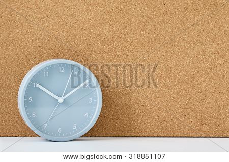 Gray Alarm Clock And Corc Board On White Table