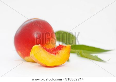 Delicious And Juicy Nectarina Peach With Leaves On White Background. Healthy Summer Fruit.