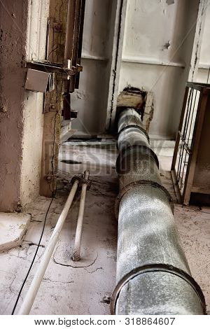 Old Empty Destroyed And Abandoned Factory With Rusty Pipe. Industrial Concept