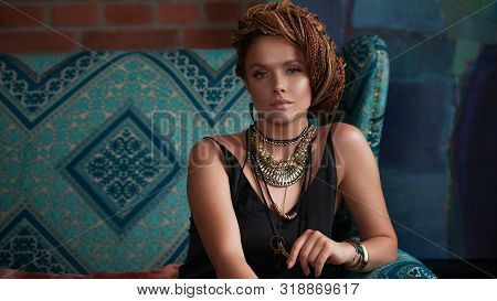 Southern Spices. Luxurious Young Woman With Afro-hairs, An Intricate Hairstyle, Blue Eyes, Highlight