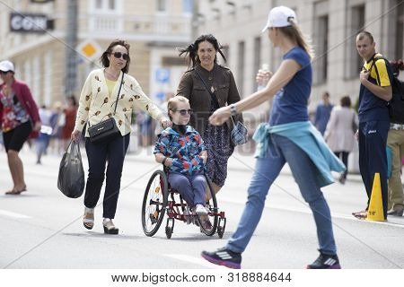 Belarus, The City Of Gimel, July 03, 2019. Youth Festival.marathon Wheelchair Disabled. The Girl Is 