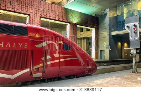 Antwerp, Belgium - June 2019: Paris Bound Thalys High Speed Train Tgv Waiting For A Red Stop Sign In