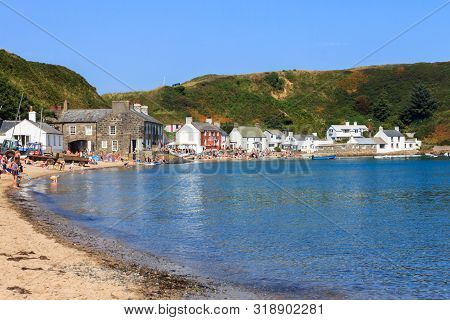 Nefyn, Wales - August 18th 2015: People Enjoying The Sunny Weather On The Sandy Beach. The Town Is S