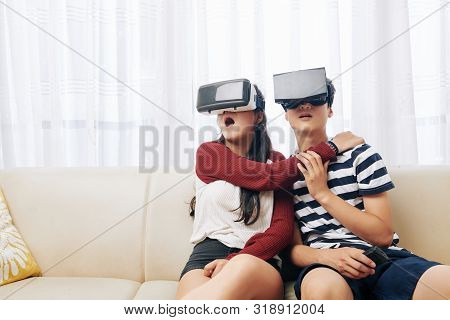 Shocked Frightened Teenage Girl Hugging Her Brother When Thay Are Playing Horror Game In Virtual Rea