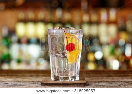 Refreshing Cocktail Tom Collins On The Bar. A Drink Based On Gin And Lemon Juice. Space For Text