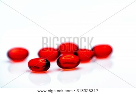Red Soft Gel Capsule Pills Isolated On White Background. Pile Of Red Soft Gelatin Capsule. Vitamins 