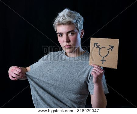 Good Looking Happy And Proud Trans Teenager Holding The Symbol Of The Transgender Drawn On A Cardboa