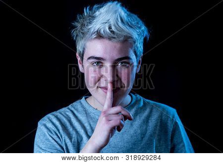 Strong Portrait Of Handsome Young Transgender Teenager Man Making Silence Gesture