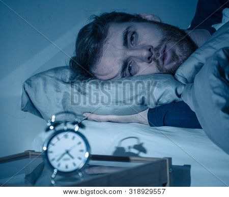 Sleepless And Desperate Young Caucasian Man Awake At Night Not Able To Sleep, Feeling Frustrated And
