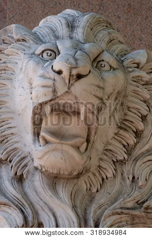 An Expressive Sculpture Of A Lion's Head Made Of White Stone. Close-up.