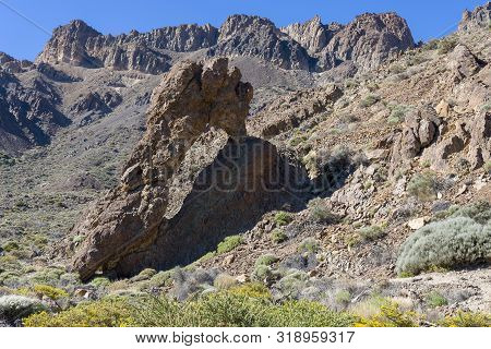 Mountains And Shrubs Near The Volcano Teide, Partially Covered With Clouds. Bright Blue Sky. Teide N