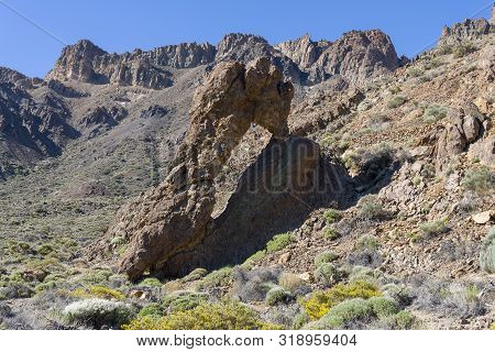 Mountains And Shrubs Near The Volcano Teide, Partially Covered With Clouds. Bright Blue Sky. Teide N