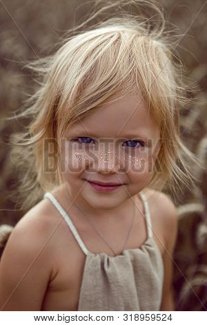 Girl In Long Dress Stands In A Field With Spikelets