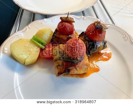 Turkish Islim Kofta Kebab With Meatballs And Cherry Tomatoes Wrapped In Eggplant / Aubergine Slices.