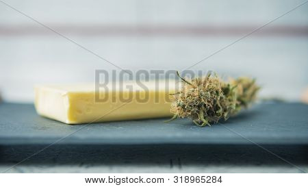 Preparing To Cooking Cake With Cannabis Butter. Concept Of Using Marijuana In Food Industry.