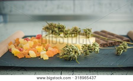 Preparing To Cooking Cake With Cannabis Butter. Concept Of Using Marijuana In Food Industry.