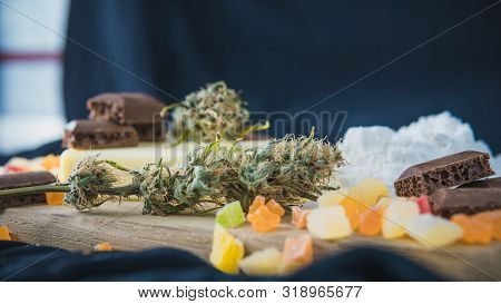 Preparing To Cooking Cake With Cannabis Butter. Concept Of Using Marijuana In Food Industry.