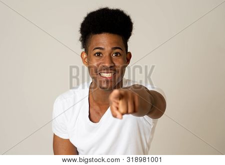 Portrait Of Handsome Shocked African American Man Pointing Out And Laughing With Surprised And Happy