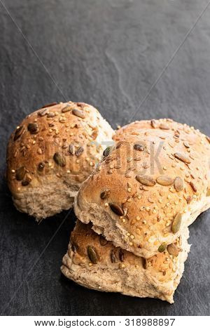 Wholemeal  Multiseeds Batch Rolls On Black Table Batch Of Four